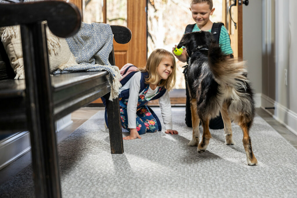 Kids playing with dog on carpet floors | Everlast Floors